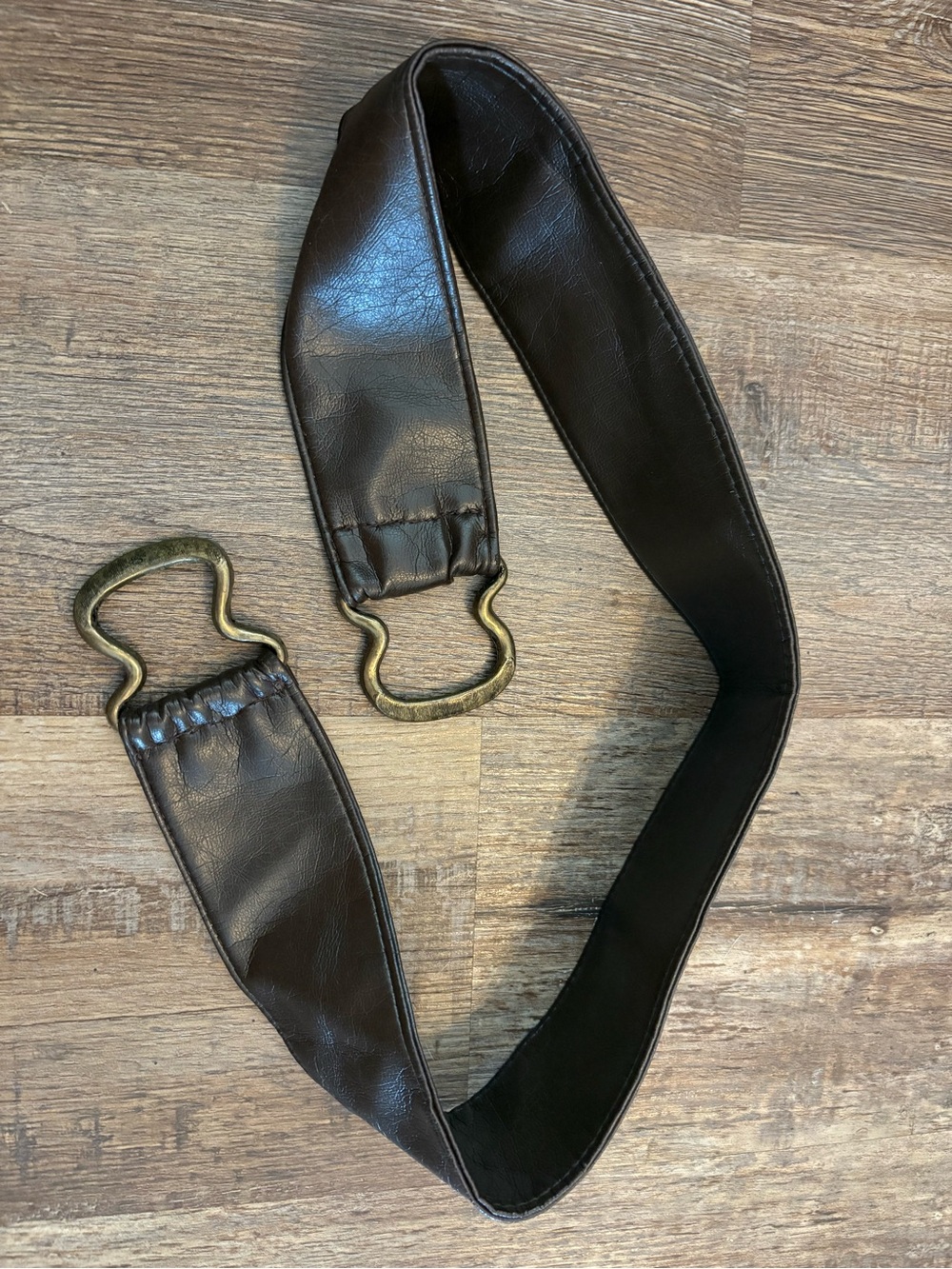 Dark brown leather equestrian-style belt with brass hoof-pick hardware